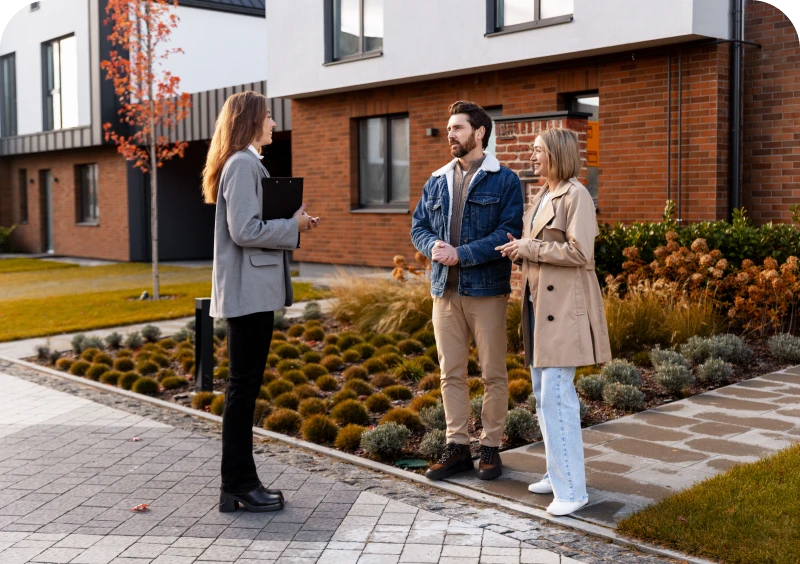 People discussing home purchase on driveway