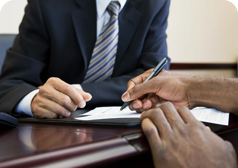 Hands signing a document